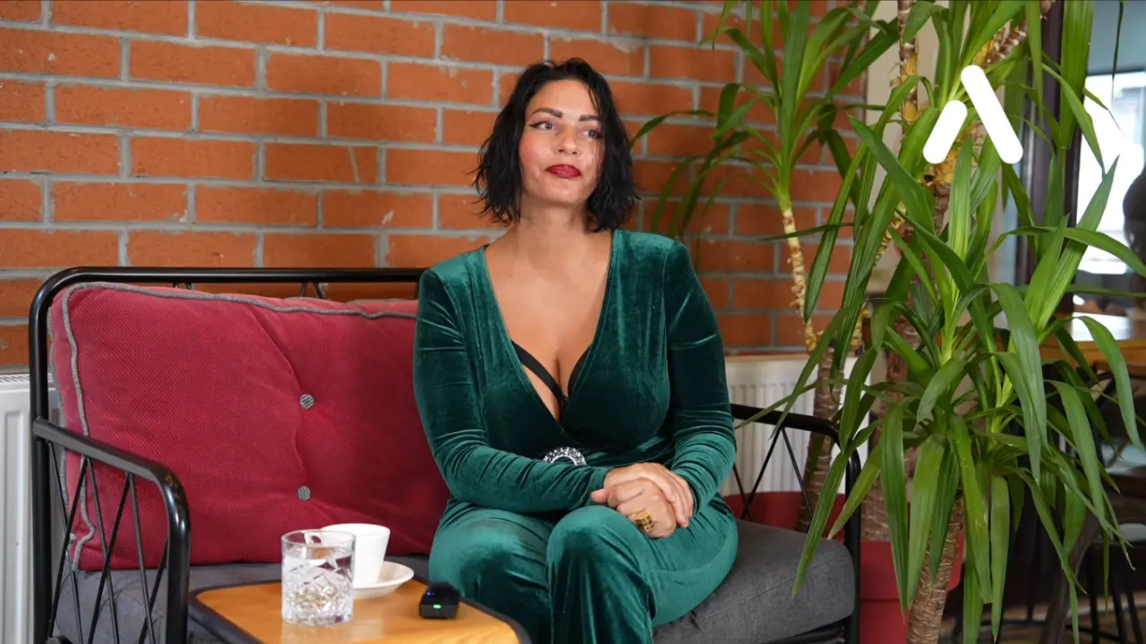 A happy female patient from Germany sharing her face and neck lift surgery results in a video interview.