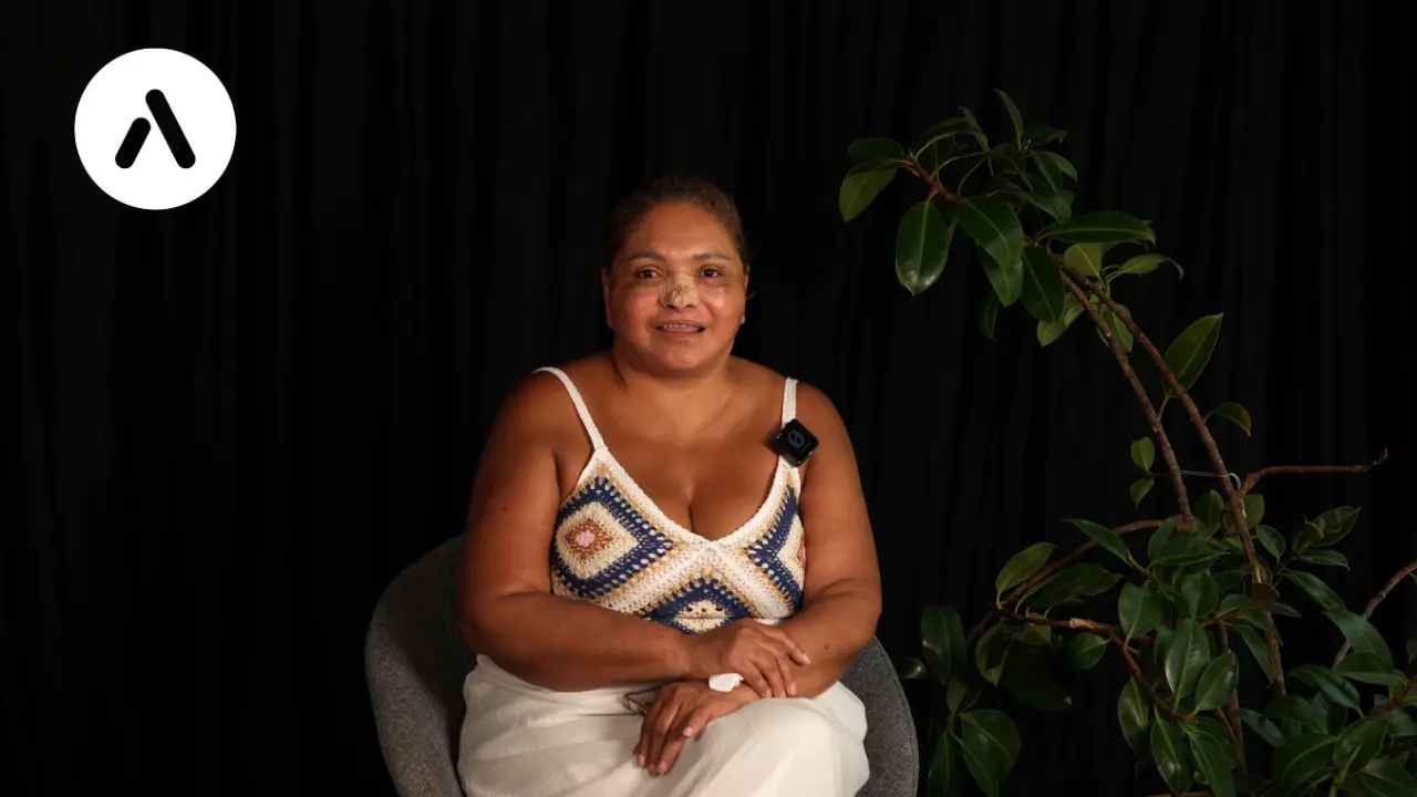 German patient sharing a video testimonial about facelift and rhinoplasty surgery results at AKM Clinic