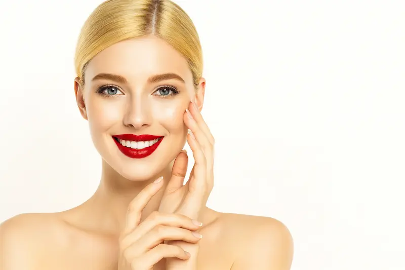 Smiling woman with smooth, glowing skin after Deep Plane Facelift Recovery in Turkey, showing natural, youthful facial contours.