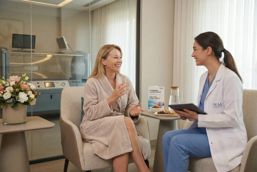 Post-op patient consultation at AKM Clinic discussing recovery support, with HBOT and low-level laser therapy information visible