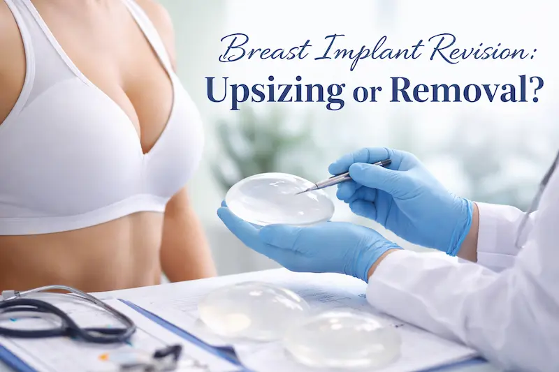Breast implant revision consultation showing a surgeon holding a silicone implant while discussing upsizing or removal options.